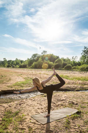 Yoga Teacher Doing Poses at the Beachの写真素材