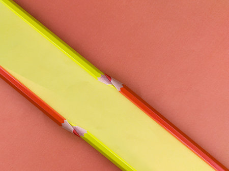 Colored pencils isolated on a red background with space for text