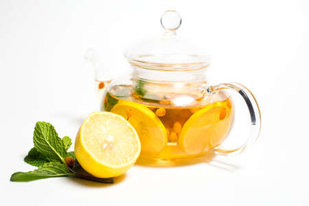 sea buckthorn tea with lemons on white backgroundの写真素材