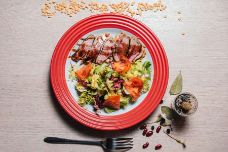 duck breast with salad and vegetablesの写真素材