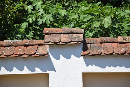 Roof tiles on the fence of the buildingの写真素材