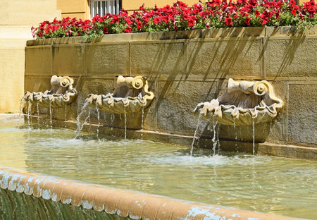 Fountains on the wall of the buildingの写真素材