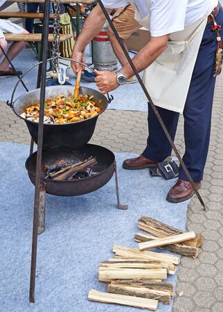 Man is cooking outdoorのeditorial素材