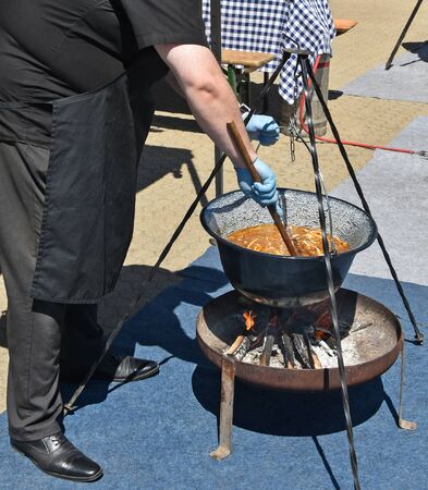 Man is cooking goulash outdoorのeditorial素材