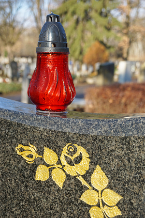 Lantern on the tombstone in the cemeteryの写真素材