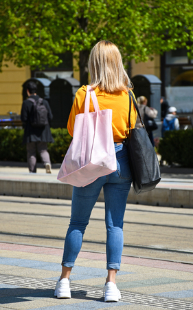 Young girl waiting at the bus stopの写真素材