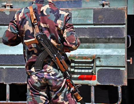 Soldier with machine guns outdoors