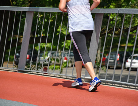 Woman is running on the running track