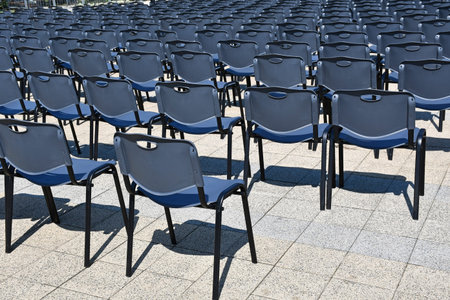Plastic chairs in a row outdoors