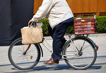 Man rides a bicycle on the city streetの写真素材