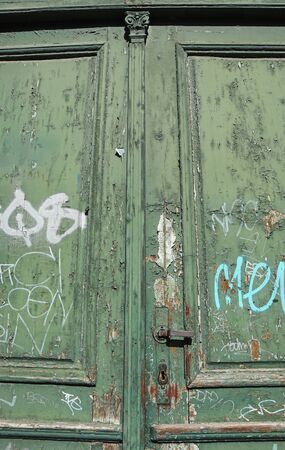 Old green door of a buildingの写真素材