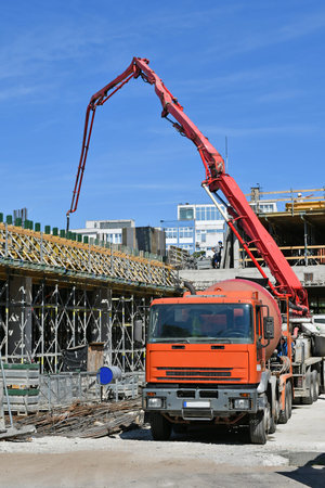 Concrete pump truck at the construction siteの写真素材