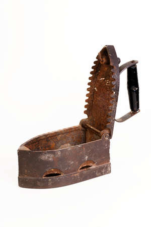 Old rusty charcoal iron opened isolated on whiteの写真素材