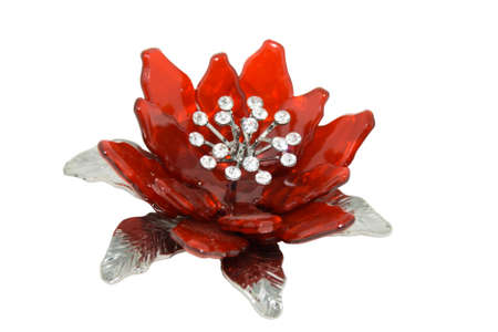 Red flower brooch isolated on black backgroundの写真素材
