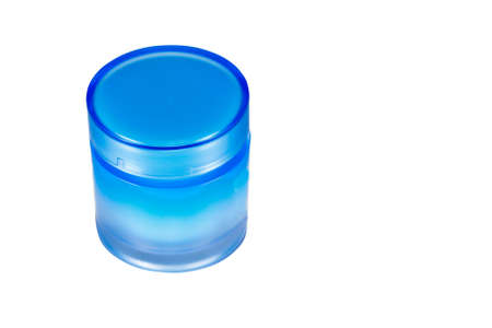 Cosmetic cream in closed blue jar isolated on white backgroundの写真素材