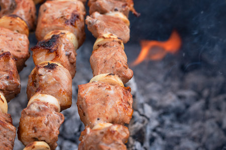 Tasty, juicy, delicious grilled skewers are fried on the grill. pieces of meat are fried on coals....