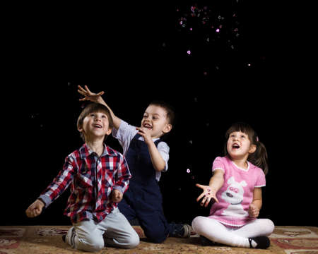 happy children playing on a black backgroundの写真素材