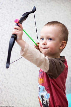 little beautiful child playing hide smiles thinkingの写真素材