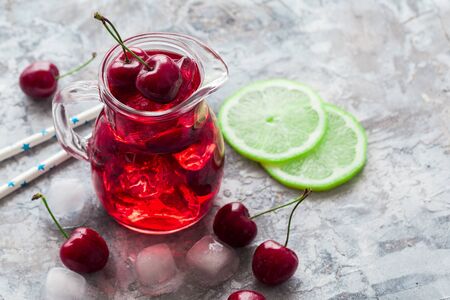 Cherry lemonade, iced summer cocktail, gray background Copy spaceの写真素材