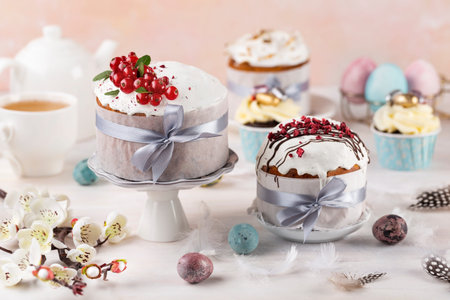 Various Spring Easter cakes eggs with white icing and sugar decor and easter eggs on the white...