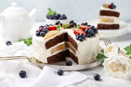 chocolate cake decorated with fresh berries on a light background. sweet concept.