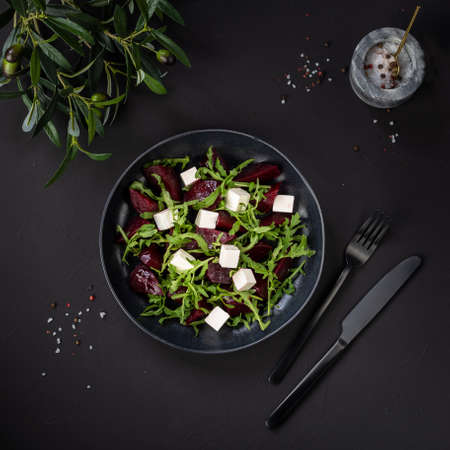 Beetroot salad with feta cheese on black backgroundの写真素材