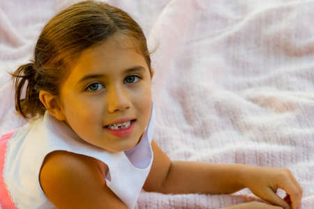 Cute girl smiles and shows off her missing toothの写真素材