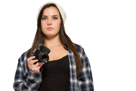Young woman with brown hair holds camera and takes pictures