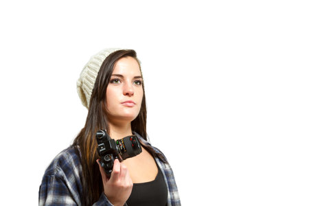 Young woman with brown hair holds camera and takes pictures
