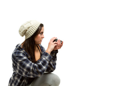 Young woman with brown hair holds camera and takes pictures