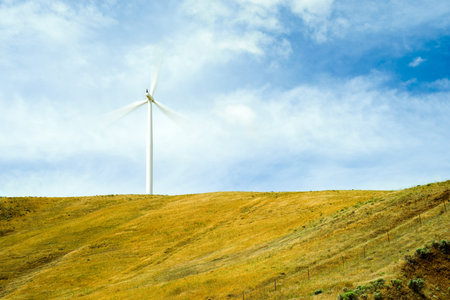 Large wind turbine farms harvest wind to create electrical energy の写真素材