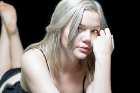 Young blonde female modeling tasteful boudoir