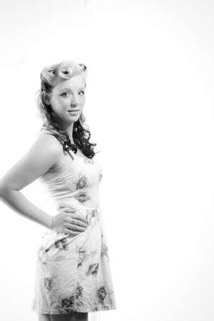 Young attractive woman in short modest dress on isolated white backgroundの写真素材