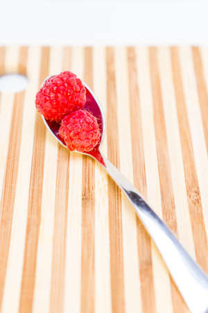 Spoonful of fresh ripe raspberriesの写真素材