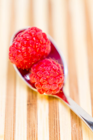 Spoonful of fresh ripe raspberries