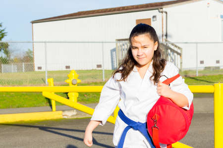 Female Martial Arts Student Gets Ride to Practiceの写真素材