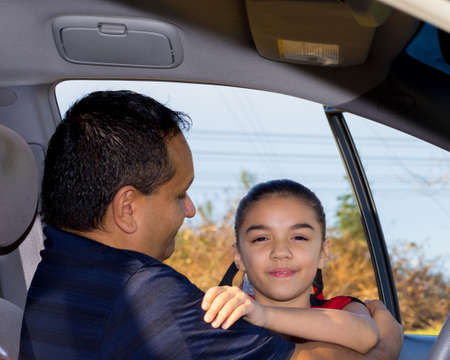 Daughter Affectionately Greets Father At Carの写真素材