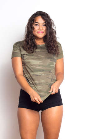Curvy young woman with curly hair and olive skinの写真素材