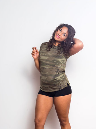 Curvy young woman with curly hair and olive skinの写真素材