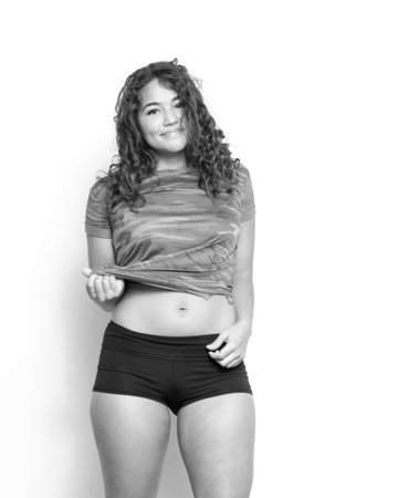 Attractive young woman in sport tee and shorts