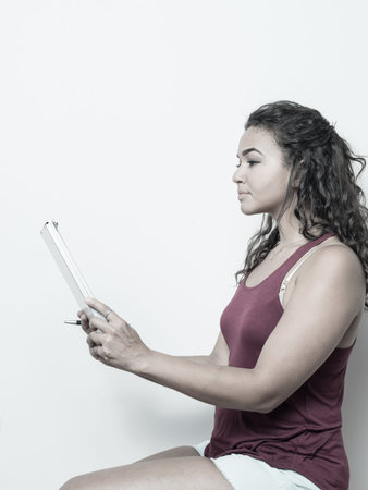 Young lady reviews papers while seated concept.