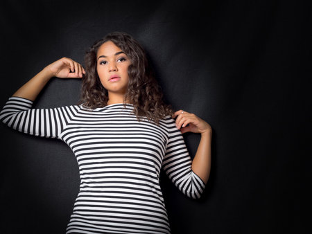 Attractive Young Woman Leaning Against Wallの写真素材