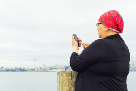 Beautiful middle aged woman using cell phoneの写真素材