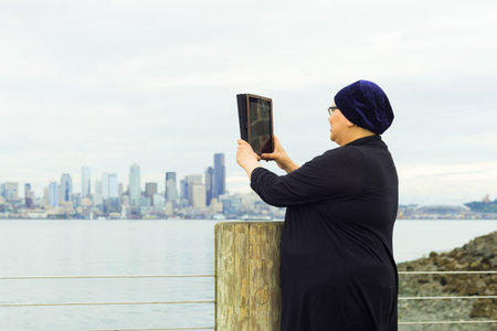 Beautiful middle aged woman resumes lifestyle post-surgery for breast cancerの写真素材