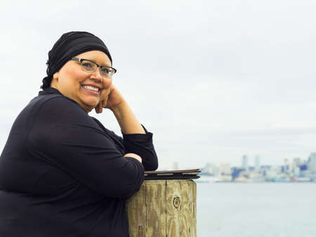 Beautiful middle aged woman resumes lifestyle post-surgery for breast cancerの写真素材