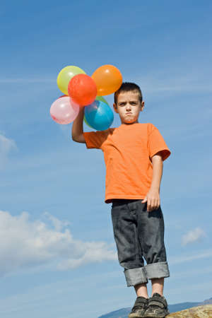 Boy imitates the inflated balloonsの写真素材