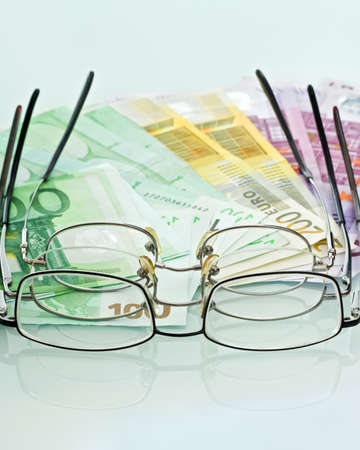 Eyeglasses and currenciesの写真素材