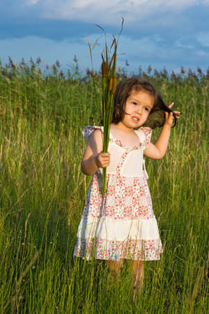 Little girl holding in her hands reedsの写真素材