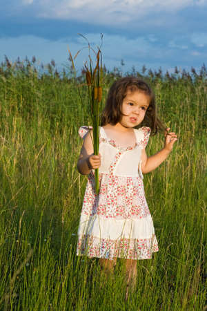 Little girl holding in her hands reedsの写真素材