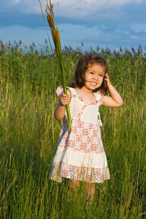 Little girl holding in her hands reedsの写真素材